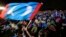 In this May 6, 2018 photo, supporters of former Malaysian strongman Mahathir Mohamad wave flag during an election campaign in Kuala Lumpur, Malaysia.