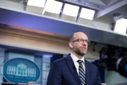 Office of Management and Budget Acting Director Russ Vought pauses as he speaks during a television interview at the White House, Feb.10, 2020, in Washington.