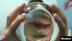 South Korean fortune teller Kim Yong-son poses with his crystal ball in his Seoul office. (File photo)