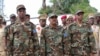 FILE - Somalia's Defense Minister Abdirashid Abdulahi Mohamed (L), watches a a military unit alongside President Mohamed Abdullahi Mohamed (C), and Somali Prime Minister Hassan Ali Khayre (R) during celebrations marking the 57th anniversary since Somali military was founded, in Mogadishu, April 12, 2017. 