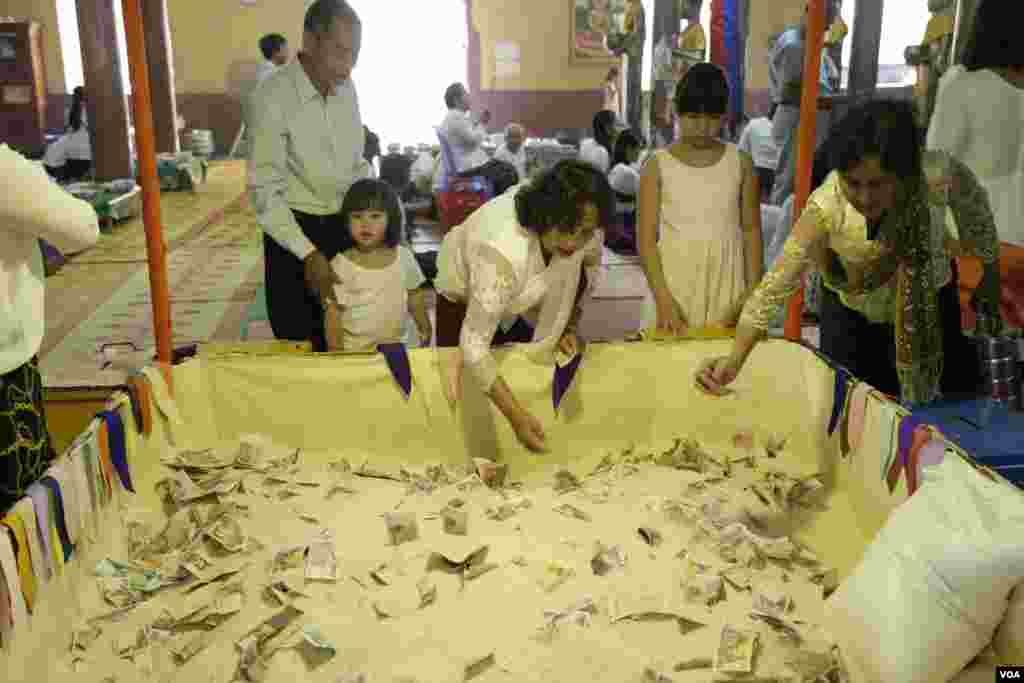 ពុទ្ធ​បរិស័ទ​ពូន​ភ្នំ​អង្ករ​​ដើម្បី​រំដោះ​កម្មពារ​តាម​ទំនៀម​ទម្លាប់​នៅ​ក្នុងវត្ត​មួយ​កណ្តាល​រាជធានី​ភ្នំពេញ​កាលពី​ព្រឹក​ថ្ងៃសៅរ៍​ ទី​១៦ ខែ កញ្ញា​​ ឆ្នាំ២០១៧។​(ទុំ ម្លិះ/VOA)