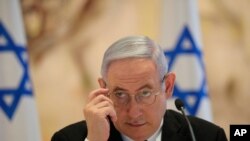 FILE - Israeli Prime Minister Benjamin Netanyahu attends the first Cabinet meeting of the new government at Chagall Hall in the Knesset, the Israeli Parliament, in Jerusalem, Israel, May 24, 2020.