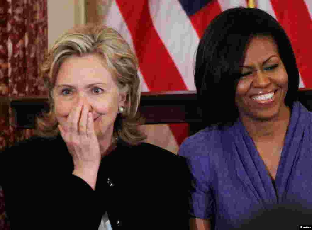 Secretaryn Clinton and first lady Michelle Obama share a laugh during their participation in the 2010 International Women of Courage Awards at the State Department in Washington, March 10, 2010. 