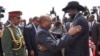 South Sudanese President Salva Kiir (r.) hugs his Sudanese counterpart Omar al Bashir as he arrives at Juba airport on Friday, April 12, 2013. The Sudanese president was visiting South Sudan for the first time since it split from Sudan in 2011.