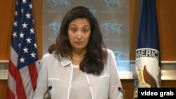 President Barack Obama bows his head during a moment of silence at the Pentagon during a ceremony to mark the 13th anniversary of the 9/11 attacks, Sept. 11, 2014.