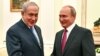 Russian President Vladimir Putin, right, shakes hands with Israeli Prime Minister Benjamin Netanyahu during their meeting at the Kremlin in Moscow, July 11, 2018.