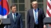 President Donald Trump and South Korean President Moon Jae-in arrive in the Rose Garden of the White House in Washington, June 30, 2017, to make statements.