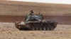 FILE - A Turkish army tank takes up position on the Turkish-Syrian border near the southeastern town of Suruc in Sanliurfa province, Sept. 29, 2014. 