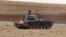 FILE - A Turkish army tank takes up position on the Turkish-Syrian border near the southeastern town of Suruc in Sanliurfa province, Sept. 29, 2014. 