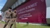 FILE - Thai policemen walk in front of a banner welcoming Association of Southeast Asian Nations in Nonthaburi province, Thailand, Oct. 29, 2019. 