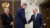 U.S. Secretary of State John Kerry, center, is welcomed by Russian President Vladimir Putin at the presidential residence of Bocharov Ruchey in Sochi, Russia, May 12, 2015. U.S. Ambassador to Russia John Tefft is at left.