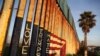 A message and the colors of the U.S. flag are seen on the U.S. and Mexico border fence at Friendship Park in Tijuana.