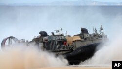 A US Navy hovercraft approaches the beach at the beginning of the NATO Trident Juncture exercise 2015 at Raposa Media beach in Pinheiro da Cruz, south of Lisbon, Oct. 20, 2015.