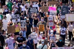 FILE - Hundreds march at a rally against racial inequality and police accountability, in Kenosha, Wisconsin, Aug. 29, 2020, following the police shooting of Jacob Blake.
