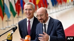 President of the European Council Charles Michel (R) talks to the media as he arrives with NATO Secretary General Jens Stoltenberg (L) for a European Council Summit, at the EU headquarters in Brussels, on June 29, 2023.