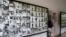 A tourist walks past photos of former prisoners displayed at Tuol Sleng genocide museum, a former Khmer Rouge prison known as S-21, in Phnom Penh.