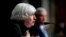 Treasury Secretary Janet Yellen, accompanied by Federal Reserve Chairman Jerome Powell, background, speaks during a Senate Banking Committee hearing on Capitol Hill in Washington, Nov. 30, 2021.