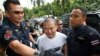 FILE - Former Buddhist monk Wirapol Sukphol is escorted by officials from the Department of Special Investigation to the prosecutor's office in Bangkok, Thailand, July 20, 2017.
