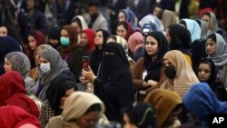 FILE - Afghan women attend an event to mark International Women's Day in Kabul, March 7, 2021.
