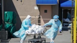 Bodies are moved to a refrigeration truck serving as a temporary morgue at Wyckoff Hospital in the Borough of Brooklyn on April 6, 2020 in New York