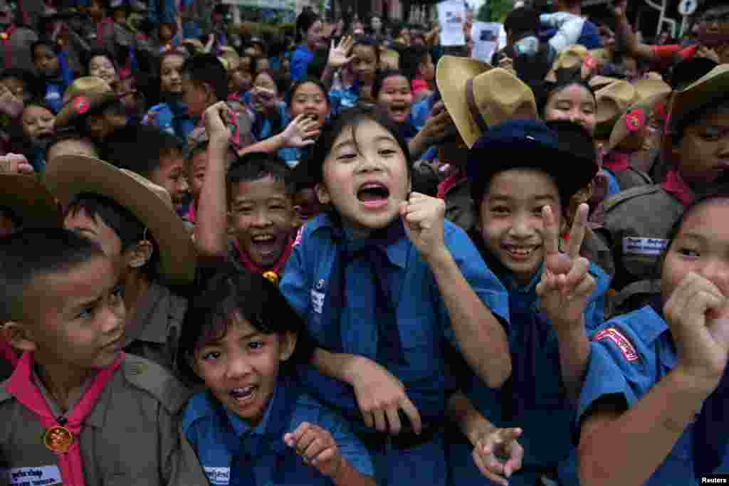 Students celebrate in front of Chiang Rai Prachanukroh hospital, where the 12 soccer players and their coach rescued from the Tham Luang cave complex are being treated, in the northern province of Chiang Rai, Thailand.