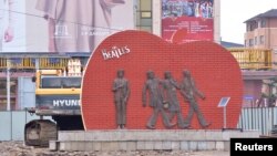 A statue of the Beatles stands, Aug. 9, 2017, in Mongolia's capital, Ulaanbaatar. It could be moved or demolished if development of the site goes forward.