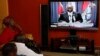 Kenyans watch as the President of the Republic of Kenya, Mwai Kibaki addresses the nation, Friday, March 1, 2013 in Nairobi, Kenya, ahead of the Monday March 4, 2013 general election. 