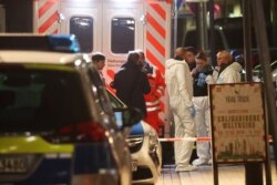 Forensic experts are seen outside a hookah bar after a shooting rampage in Hanau, Germany, Feb. 20, 2020.