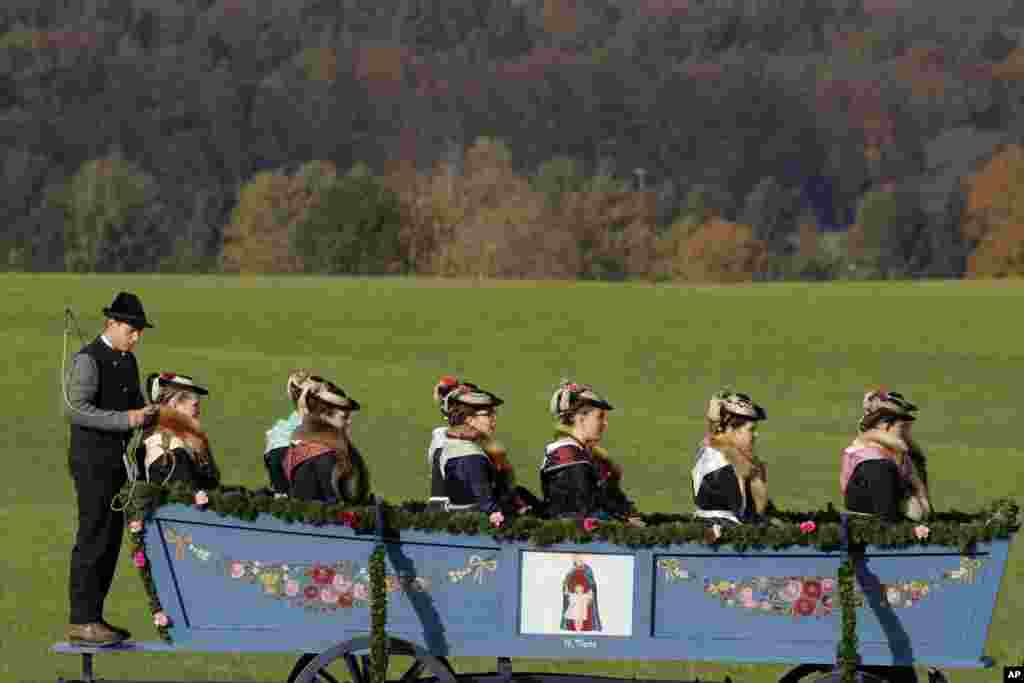 Women in their costumes of the region sit in a horse-drawn carriage during the traditional Leonhardi pilgrimage in Warngau near Munich, Germany.&nbsp;The annual pilgrimage honors St. Leonhard, patron saint of the highland farmers for horses and livestock.