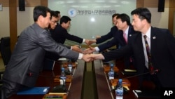 In this photo released by Unification Ministry, South Korean delegates, right, shake hands with their North Korean counterparts at Kaesong Industrial District Management Committee meeting, Kaesong, North Korea, Sept. 11, 2013.