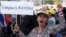 A Thai anti-government protester holds a placard and chants slogans during a rally at Victory Monument intersection, Jan. 21, 2014 in Bangkok, Thailand. 