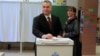 Hungary's Prime Minister Viktor Orban casts his ballot next to his wife Aniko Levai inside a polling station during a referendum on EU migrant quotas in Budapest, Hungary, October 2, 2016. 
