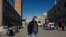 A man wearing a protective mask walks through an empty Saint Mark's Square in Venice as Italy battles a coronavirus outbreak, Venice, Feb. 27, 2020.