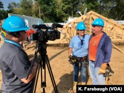 Country music icons Garth Brooks and Trisha Yearwood are just two volunteers among hundreds in what is a massive volunteer effort on the outskirts of South Bend, Ind., to build nearly two dozen homes.