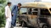 People look at the van in which Ambreen Riasat was burned in the village of Makol outside Abbottabad, Pakistan, May 6, 2016. 