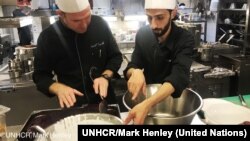 Chef of the Hotel d’Angleterre, Michael Coquelle, left, and Chef Nadeem Khadem al-Jamie, who is also a Syrian refugee, work together in the hotel's kitchen for the Refugee Food Festival, Oct. 11, 2017.