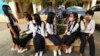 Students wearing face-masks, wait for their morning school class at Santhormok high school, in Phnom Penh, Cambodia, Monday, Nov. 2, 2020. (AP Photo/Heng Sinith)