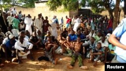 People sit on the ground after being freed by police from an Islamic rehabilitation centre in Ibadan, Nigeria in this picture released by Nigeria Police November 5, 2019. (Nigeria Police/Handout via REUTERS)