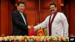 Sri Lankan President Mahinda Rajapaksa, right, shakes hands with Chinese President Xi Jinping during their meeting in Colombo, Sri Lanka, Sept.16, 2014.