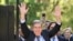 Venezuelan opposition leader Edmundo Gonzalez Urrutia (Front) waves to supporters next to Uruguay's President Luis Lacalle Pou after a meeting at the Suarez and Reyes presidential residence in Montevideo on January 4, 2025.