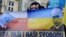 Czech Republic – Protestor holds anti Putin banner during a rally in protest against the Russian military actions in Crimea, in Prague, Czech Republic, 08 March 2014