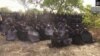 FILE - In this photo taken from video by Nigeria's Boko Haram terrorist network, Monday May 12, 2014 shows the alleged missing girls abducted from the northeastern town of Chibok. The new video purports to show dozens of abducted schoolgirls, covered in jihab and praying in Arabic. 