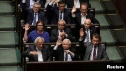 FILE - Leader of Law and Justice (PiS) party Jaroslaw Kaczynski votes on a contested Supreme Court law in Warsaw, Poland, July 20, 2017.