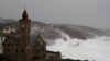 FILE - Powerful waves break on the shoreline around the small port of Porthleven, south west England, Feb. 16, 2020. 