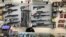 FILE - Weapons hang in a gun shop, Feb. 19, 2021, in Salem, Ore. 