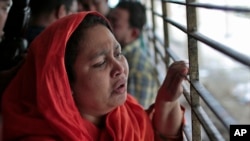 Shilpi, a cousin of late Bangladeshi blogger Washiqur Rahman Babu, wails outside a morgue at the Dhaka Medical College in Dhaka, Bangladesh, March 30, 2015.