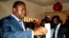 FILE - President of Togo Faure Gnassingbe (L) casts his ballot inside a school in Lome Jul. 25, 2013.
