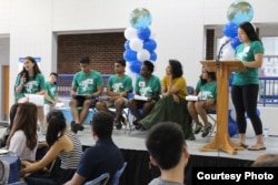 FILE - Student leaders and a professor at Duke University lead a presentation for new international students.