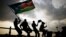 Southern Sudanese wave flags and cheer at the Republic of South Sudan's first national soccer match in the capital of Juba, July 10, 2011. 