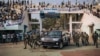 FILE - A vehicle carrying the president of the Central African Republic, Faustin-Archange Touadera, arrives at a stadium for an election rally, in Bangui, Dec. 19, 2020.